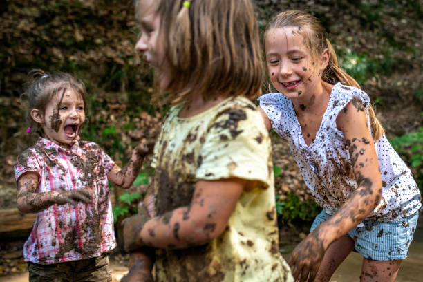istock Three young girls playing with mud 1059740530