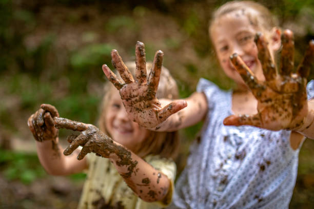 istock Smiling little muddy girls 1059740680