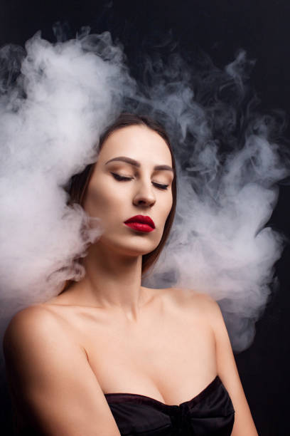 istock Attractive young girl and white smoke. 1059742060