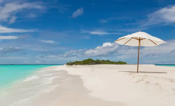 Beach umbrella on the beach Atoll island Maldives.