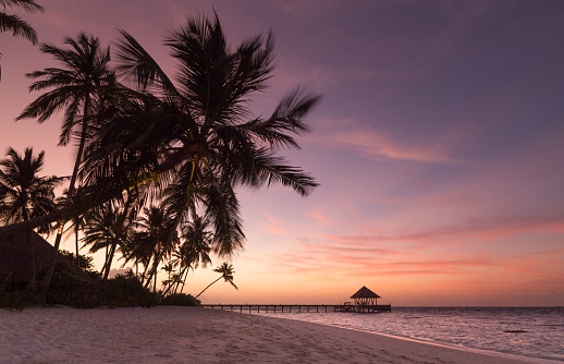 Sunset on the beach Atoll island Maldives.
