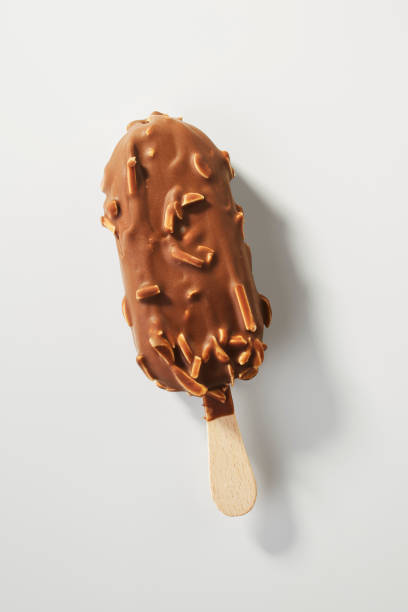 istock Hand holding Chocolate almonds Ice cream bar isolate on white background 1059744396
