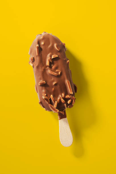 istock Hand holding Chocolate almonds Ice cream bar isolate on white background 1059744400