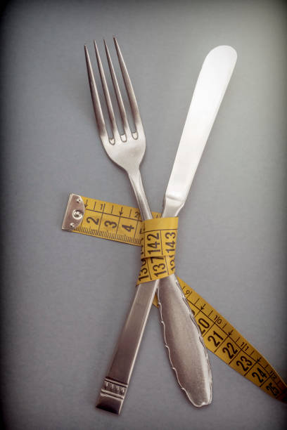 istock Holder and knife held by one meter, concept of diet 1059744568