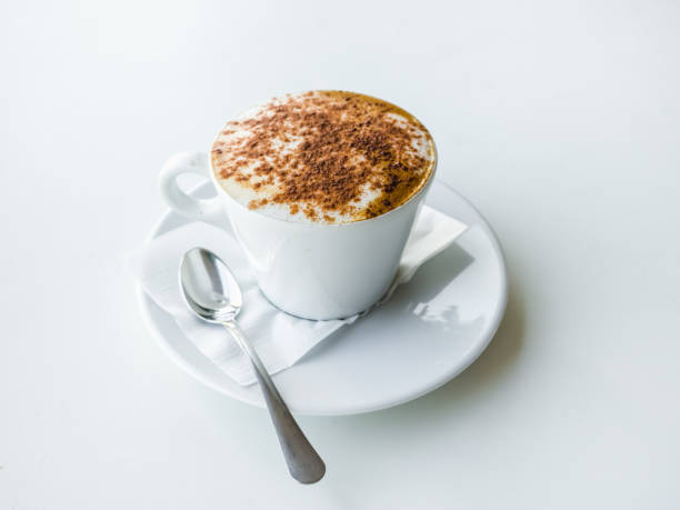 istock White Cup of cappuccino on a white table. 1059749900