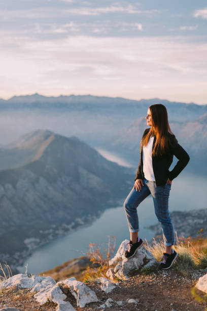 istock woman relax in mountains at sunset 1059752638