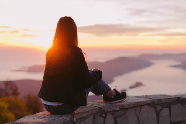 istock woman relax in mountains at sunset 1059752644