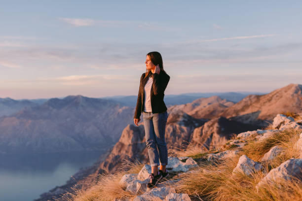 istock woman relax in mountains at sunset 1059752654
