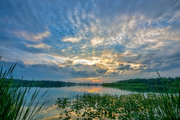 istock Sunbeams at Sunset over Water 1059752852