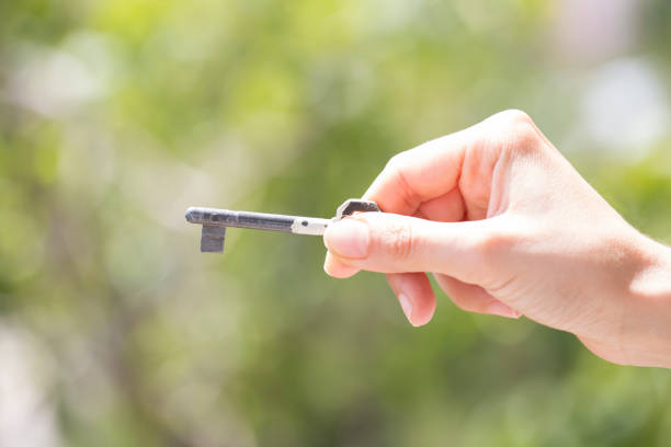 istock woman hand holding key 1059753140