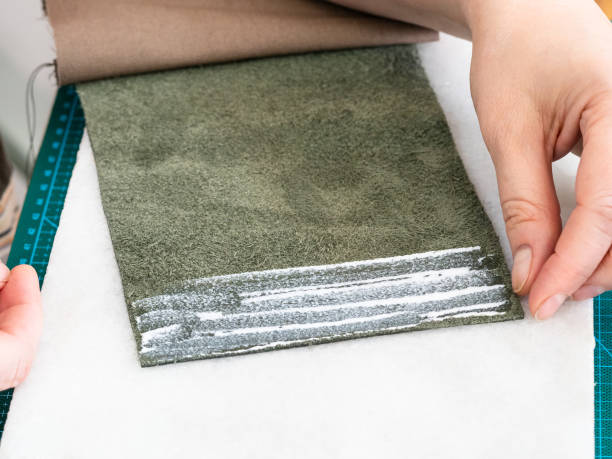 istock craftsman puts a layer of glue on the pocket edge 1059755296