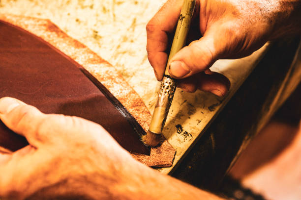 istock A saddle maker making a custom made saddle.  Real person, real life. 1059755510