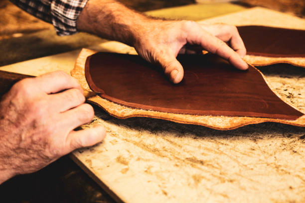 istock A saddle maker making a custom made saddle.  Real person, real life. 1059757802