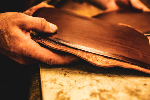 istock A saddle maker making a custom made saddle.  Real person, real life. 1059758682