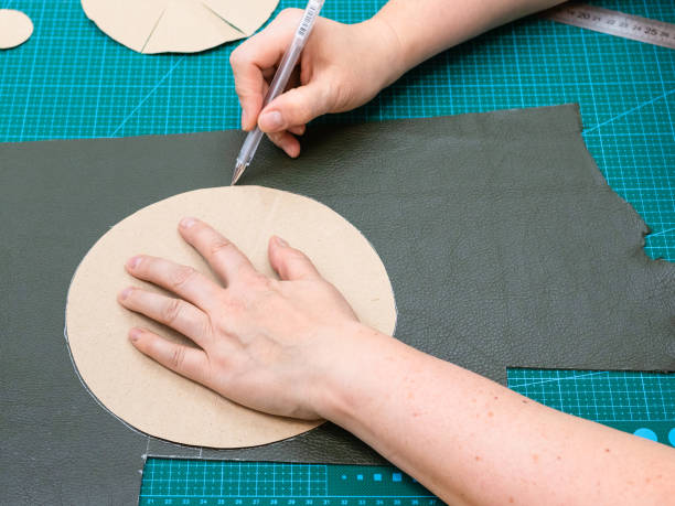 istock craftsman draws cutting pattern of the pouch item 1059763628