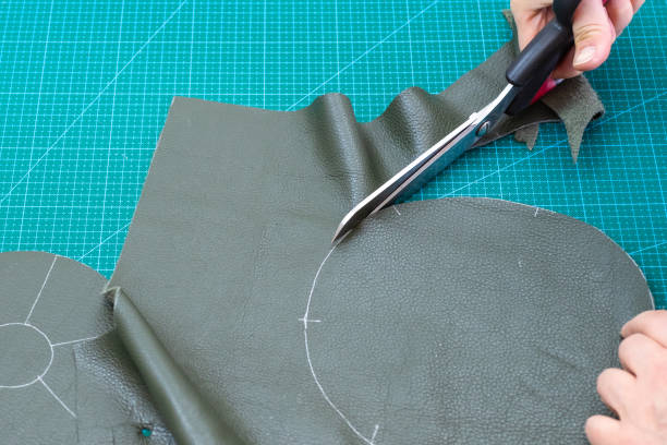 istock craftsman cuts the bottom of pouch from leather 1059763658