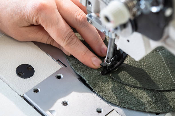istock craftsman stitches the layers on sewing machine 1059763700
