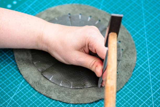 istock craftsman makes holes in stitched pouch by punch 1059763706