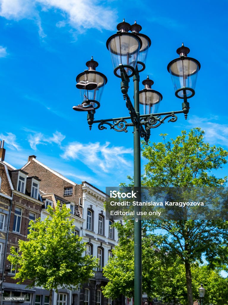 bedrijf rommel vooroordeel A Pair Of Nike Sneakers Hanging By The Laces From A Street Lamp A Shoe  Dangling In Maastricht Netherlands Stock Photo - Download Image Now - iStock