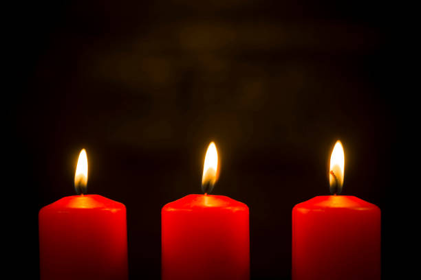 istock Lit red candles on a dark background 1059766350