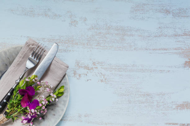 istock Rustic table setting with purple flowers on light wooden table. 1059766558