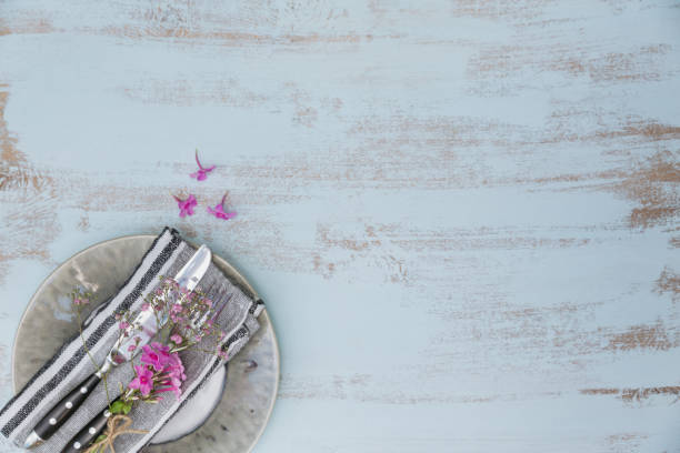 istock Rustic table setting with pink flowers on light wooden table. 1059766562
