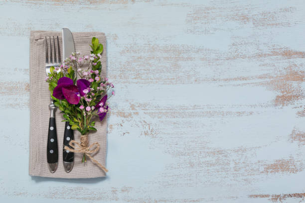 istock Rustic table setting with purple flowers on light wooden table. 1059766568
