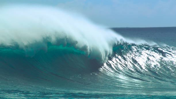 istock CLOSE UP: Massive glassy ocean wave splashing towards remote tropical island. 1059767146