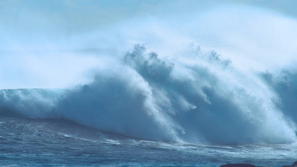 istock CLOSE UP: Large breaking ocean wave crashes and splashes near exotic island. 1059767192