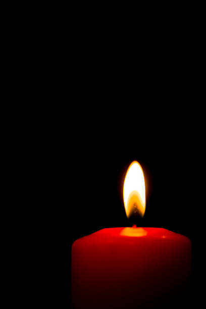 istock Lit red candle on a black background 1059770414