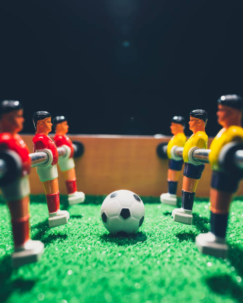 istock table football soccer kicker game players 1059771690