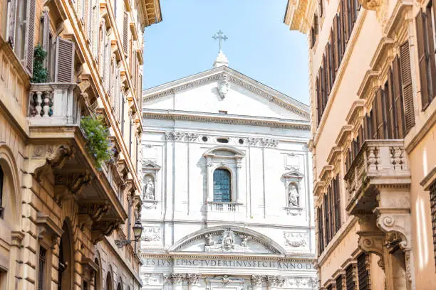 Rome, Italy historic city with church Oratory of Saint Philip Neri, summer day closeup with sky between buildings on street alley, exterior, cross, Vicolo dell'Avila