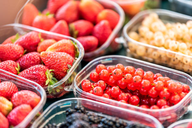 istock Many plastic containers boxes of berries, white and red currants, blackberries, on display in farmers market 1059772512