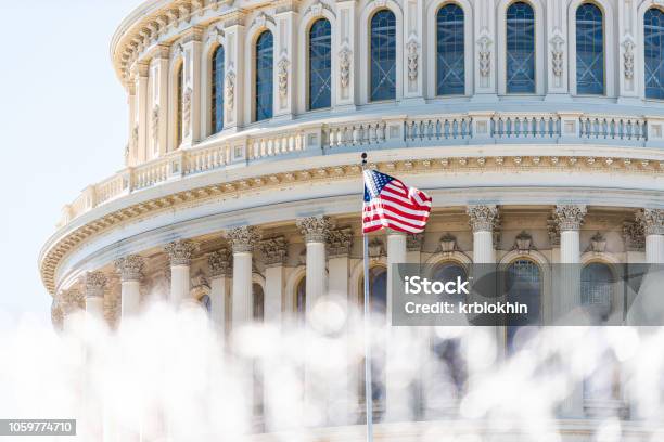 Us Congress Dome Closeup With Background Of Water Fountain Splashing American Flag Waving In Washington Dc Usa Closeup On Capital Capitol Hill Columns Pillars Nobody Stock Photo - Download Image Now