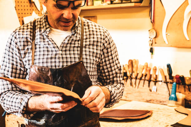 istock A saddle maker making a custom made saddle.  Real person, real life. 1059775242