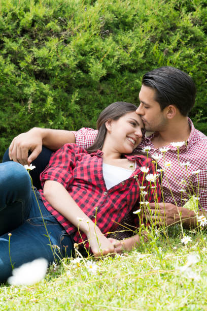 istock Couple in love on the grass 1059777894