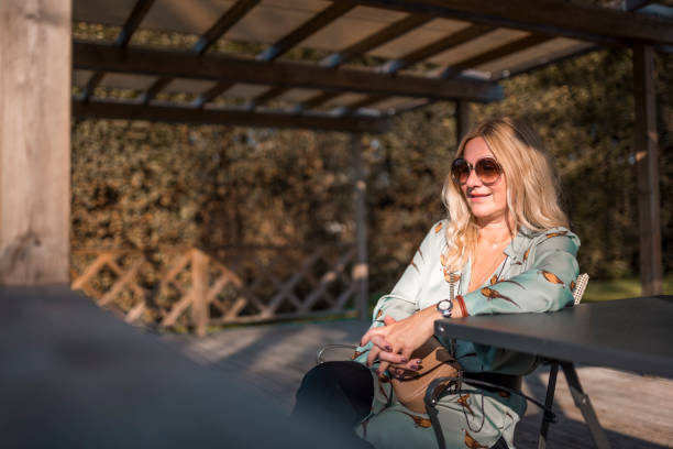 istock Woman sitting outdoors 1059783392