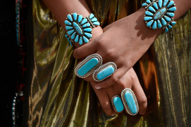 Indigenous Peoples Day Santa Fe, NM - October 8, 2018: A Native-American woman from Zuni Pueblo in New Mexico wears traditional Zuni turquoise jewelry at Indigenous Peoples Day in Santa Fe, New Mexico. indigenous peoples day stock pictures, royalty-free photos & images