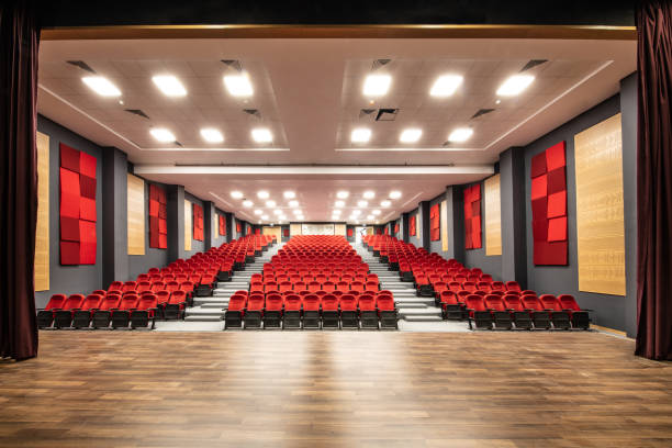 Empty red cinema hall seats, chairs. Perspective view
