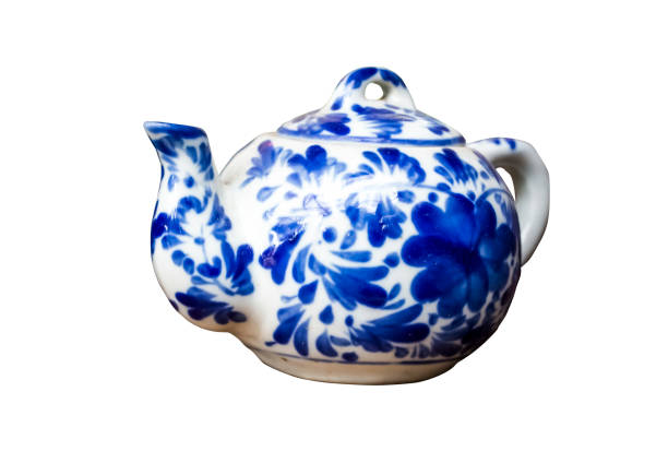 white teapot on a background of blue wicker mat, soft selective focus.
