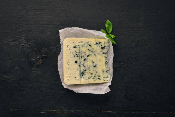 istock Blue cheese Cheese with mildew. Top view. On a wooden background. Free copy space. 1059789236
