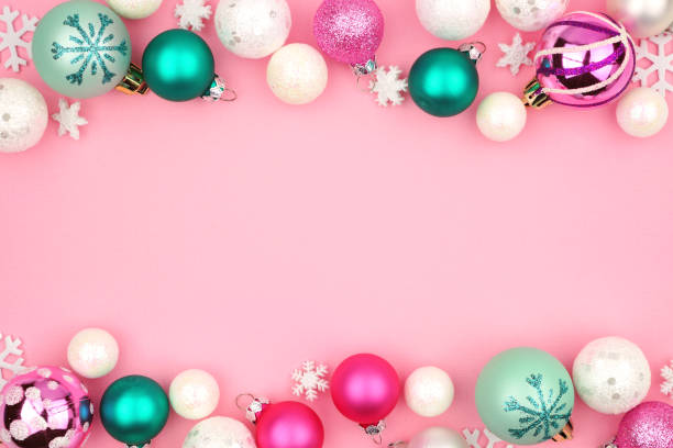 istock Pastel Christmas bauble double border over a pink background 1059789548