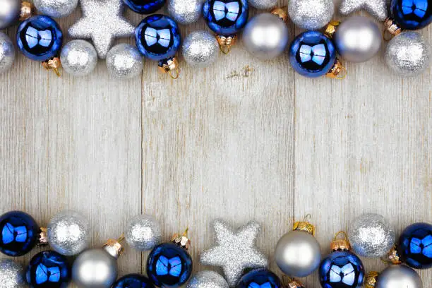 Photo of Christmas double border of blue and silver ornaments on gray wood