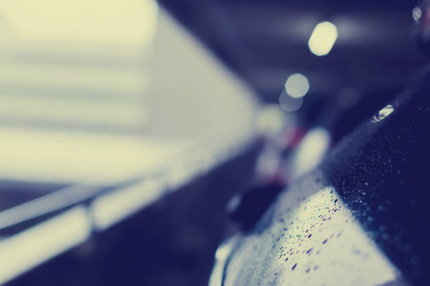 istock selective focus to rain water drops on black car texture 1059794328