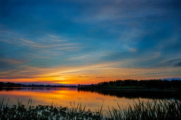 istock Calm Clouds at Sunset over Lake in Indiana 1059801486