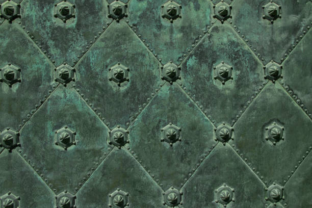 istock Metal ancient background with green iron decorative figures 1059801786