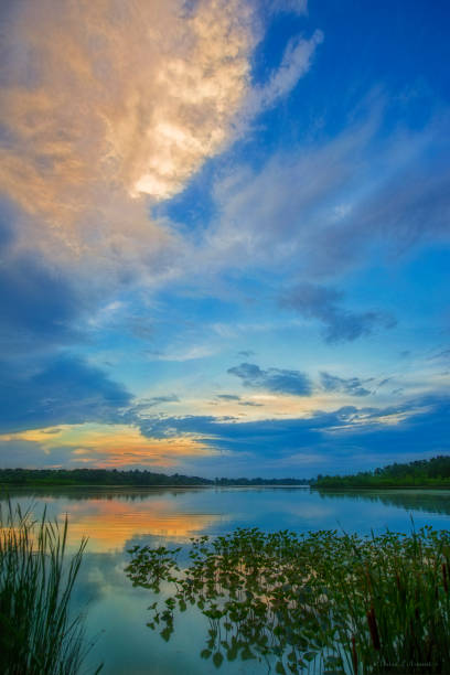 Vertical Image of Dramatic Clouds over Lake at Sunset