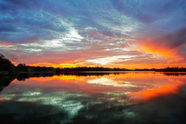 istock Fire in the Sky over Lake at Sunset 1059810786