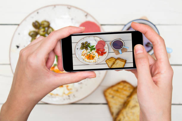 istock Woman taking a photo of breakfast table. 1059818942