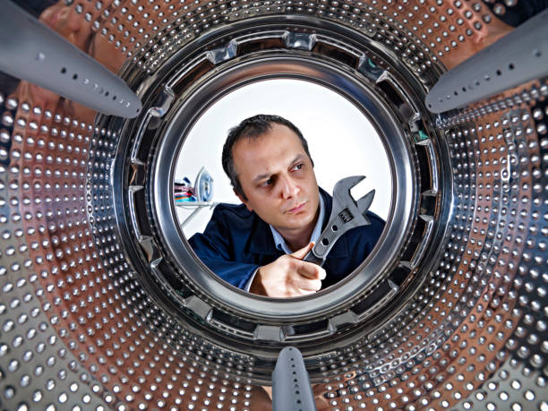 istock repairman fixing the washer 1059826858